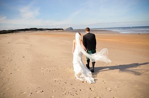 Newlyweds walking on beach