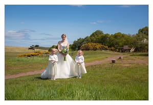 Bride and flower girls at farm wedding venue Scotland