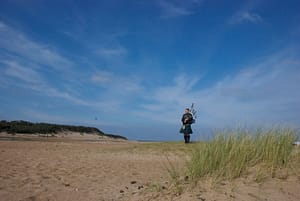 bagpipe player on the beach