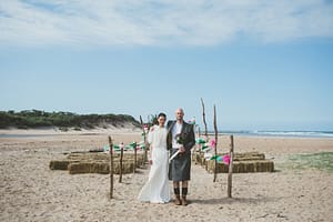 Couple getting married on the beach at Harvest Moon