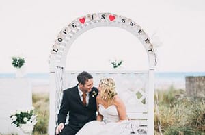 Couple getting married at the beach at Harvest Moon Weddings